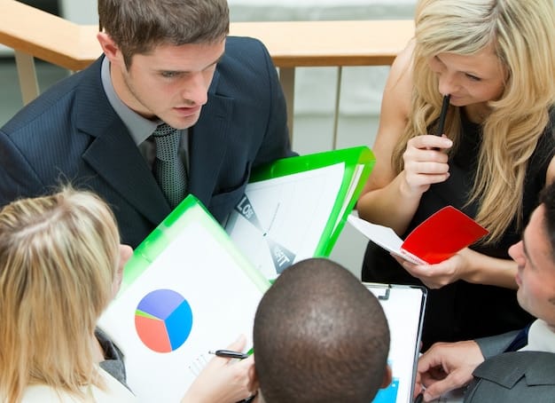 A group of business professionals collaborating around a table, reviewing charts and graphs, symbolizing strategic decision-making.