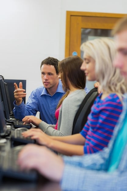A classroom setting in a vocational training center, where adults are learning new technical skills on computers, with an instructor guiding them. The atmosphere is supportive and focused on skill development.