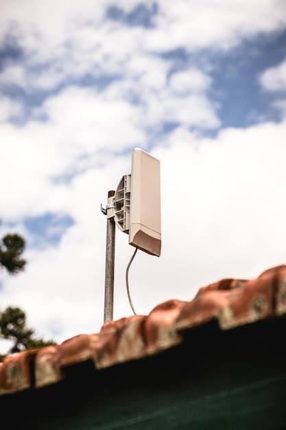 A close-up of a Starlink user terminal (dish) installed on the roof of a rural home, illustrating how the service provides internet access in remote areas.