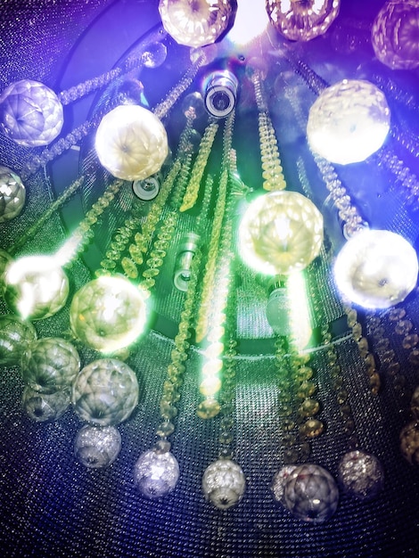 A photograph of a quantum computer being developed in a US laboratory, showcasing the complex wiring and cryogenic cooling systems required for its operation. Scientists in cleanroom suits are seen working on the device.