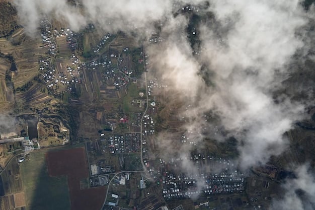 A satellite view depicting multiple wildfires burning intensely across a region, with smoke plumes obscuring the sky overhead. The image emphasizes the broad geographical impact of wildfires on infrastructure like powerlines and communication towers.