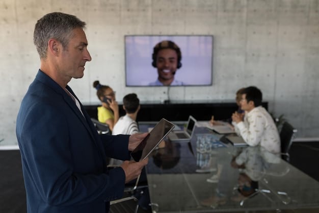 A diplomat in a modern, light-filled office, engaged in a video conference with multiple international participants visible on a large screen, discussing global health initiatives. The diplomat is gesturing, indicating an active role in the conversation.