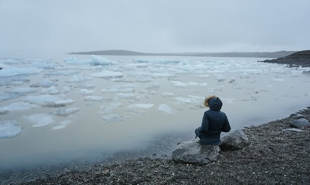 An indigenous Arctic community observing melting permafrost and shifting sea ice, symbolizing climate impact on traditional ways of life.