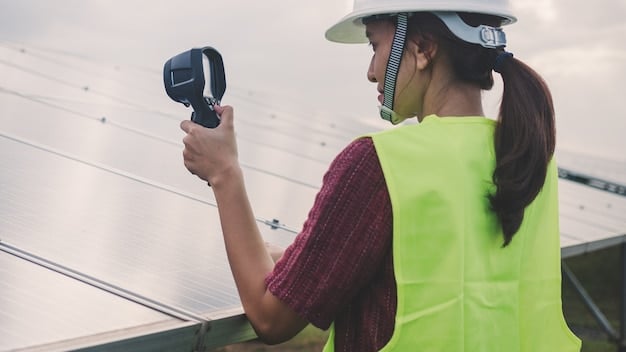 An energy auditor using a thermal imaging camera to inspect a building's insulation for heat loss, focusing on windows and walls.