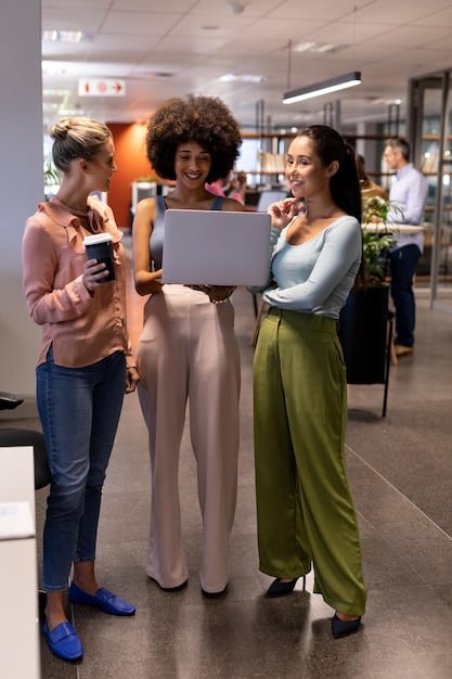A diverse group of business professionals in a modern, brightly lit office collaborating around a large touchscreen display, analyzing charts and digital dashboards related to business performance and automation metrics.