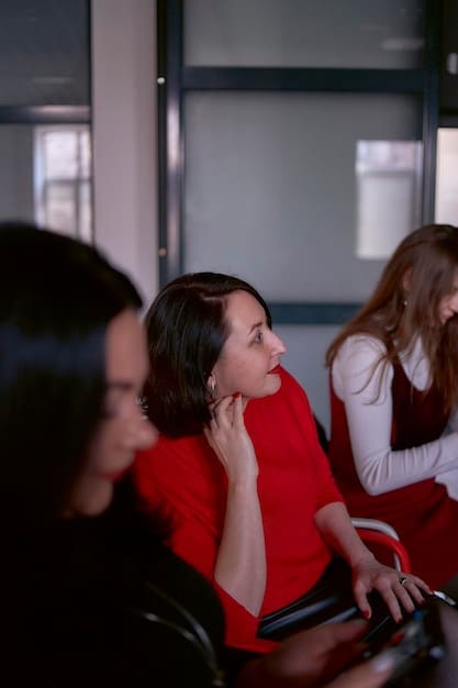 A dynamic image of a female entrepreneur passionately delivering a pitch to a panel of diverse investors, who are attentively listening.