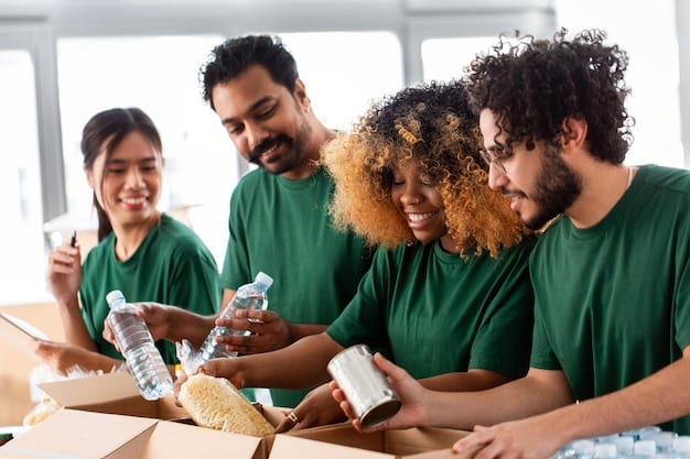 A group of diverse community members participating in a workshop on waste reduction and recycling. The presenter is gesturing towards a display of recyclable materials, and participants are engaged in discussion.