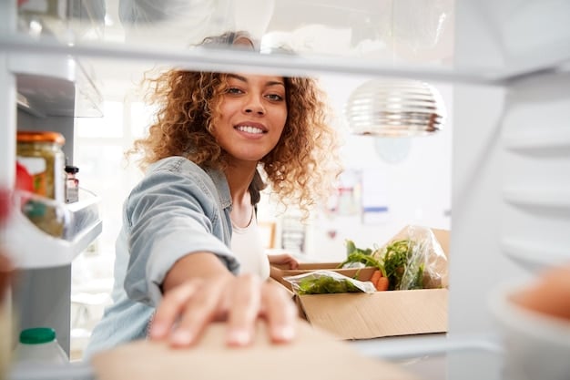 A person in a home kitchen efficiently organizing their refrigerator, with clearly labeled containers and fresh produce, demonstrating effective food storage and meal prep to reduce household waste.