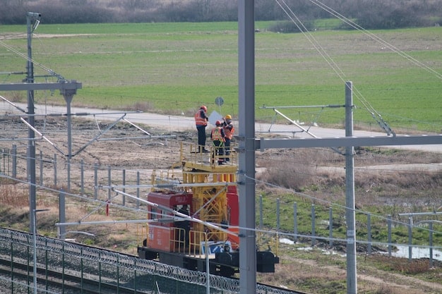 A bustling construction site showing workers installing large industrial batteries for grid-scale energy storage, emphasizing safety and modern equipment.