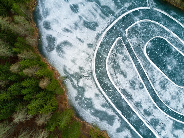 A drone shot showing a clear line between fresh river water and encroaching salty ocean water in an estuary near a US coastal area, highlighting the salinity gradient and potential for intrusion. The vivid blue and greener colors contrast sharply.